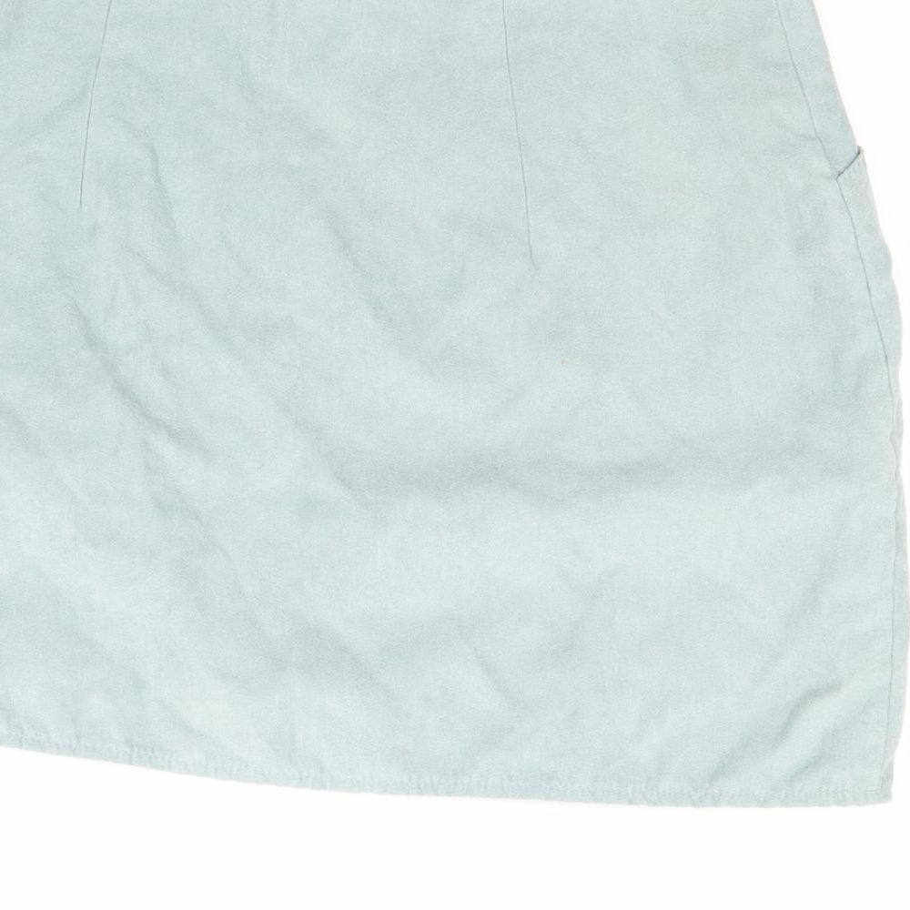 Brand and care label for Atmosphere women’s green mini skirt, size UK 12