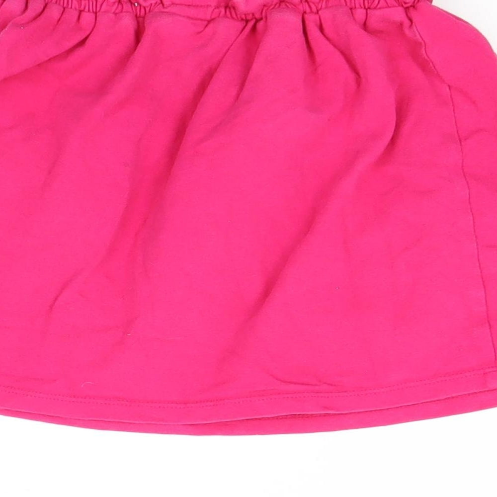 Brand and care label for Gap girls’ pink mini skirt, size 4, years