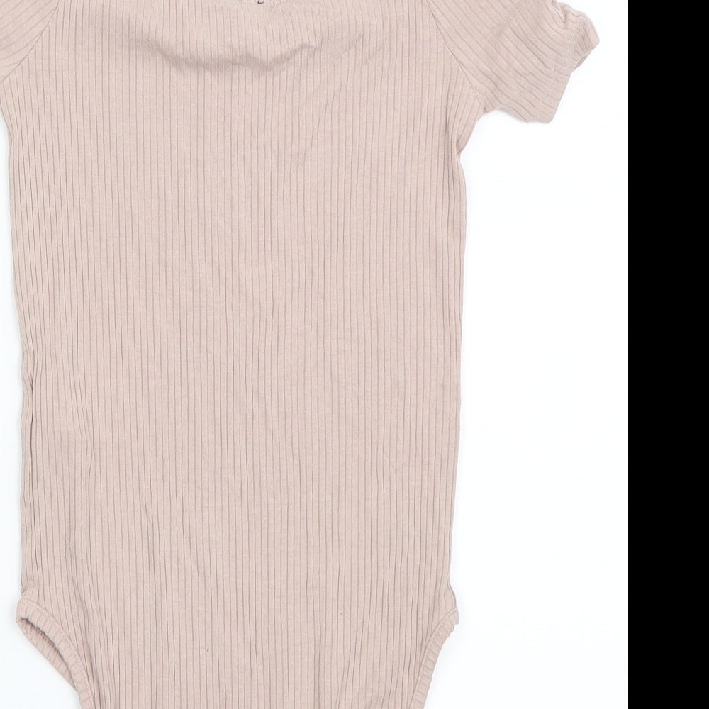 Brand and care label for Topshop women’s pink bodysuit one-piece, size UK 6