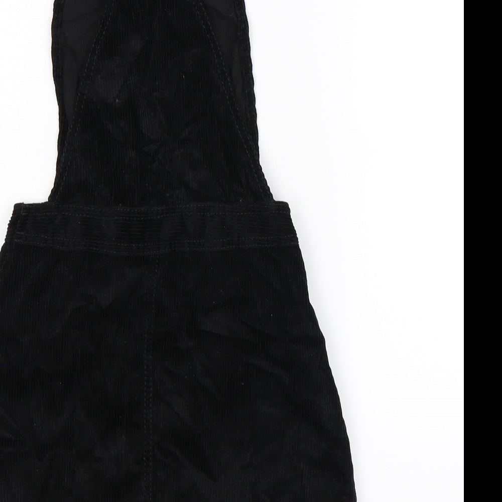 Brand and care label for BDG women’s black corduroy pinafore/dungaree dress size 2xs