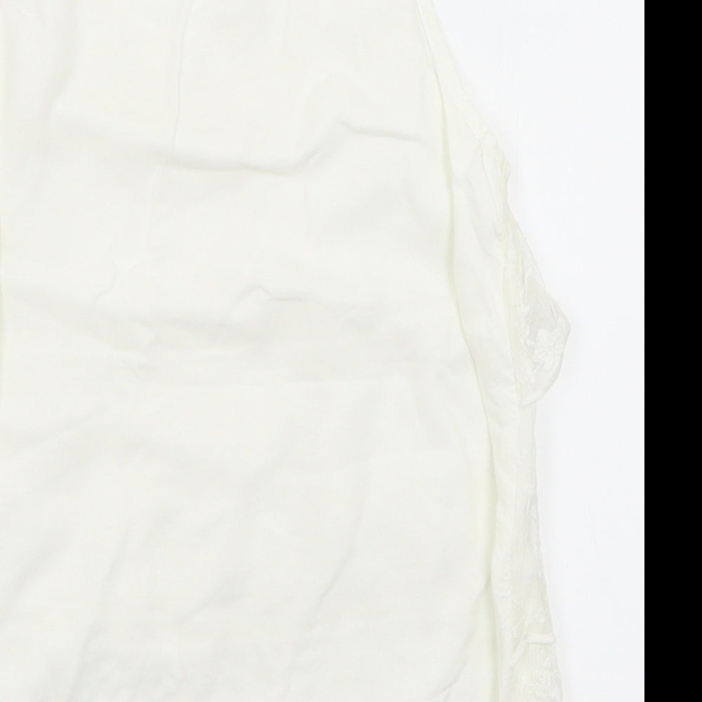 Brand and care label for H&M girls’ white basic blouse, size 10-11, years