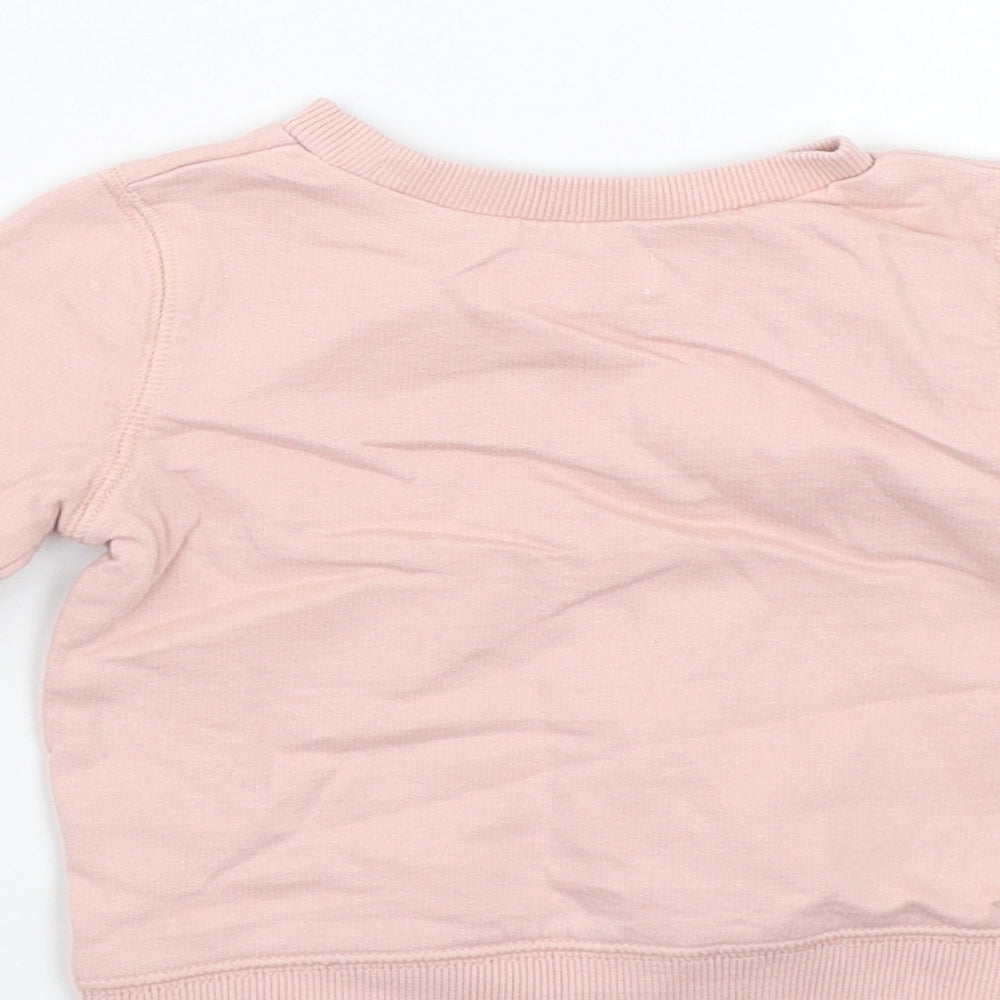Brand and care label for M&Co girls’ pink jumper, size 3-6, months