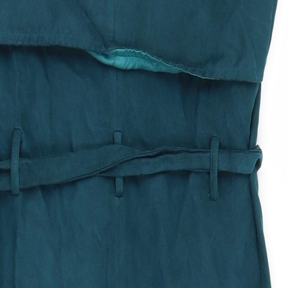 Brand and care label for Missguided women’s blue gilet jacket, size UK 4