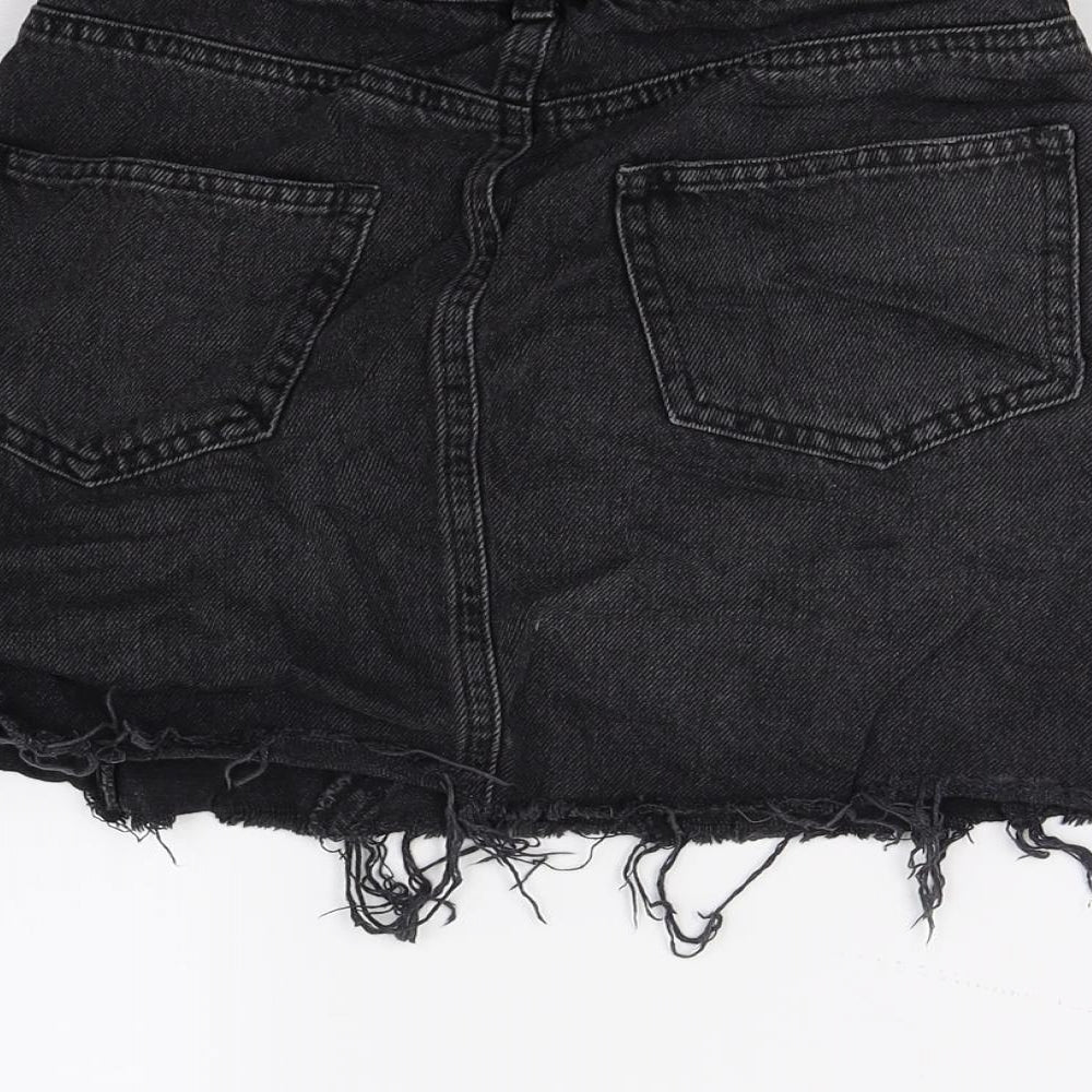 Brand and care label for Miss Selfridge women’s black denim a-line skirt, size UK 6