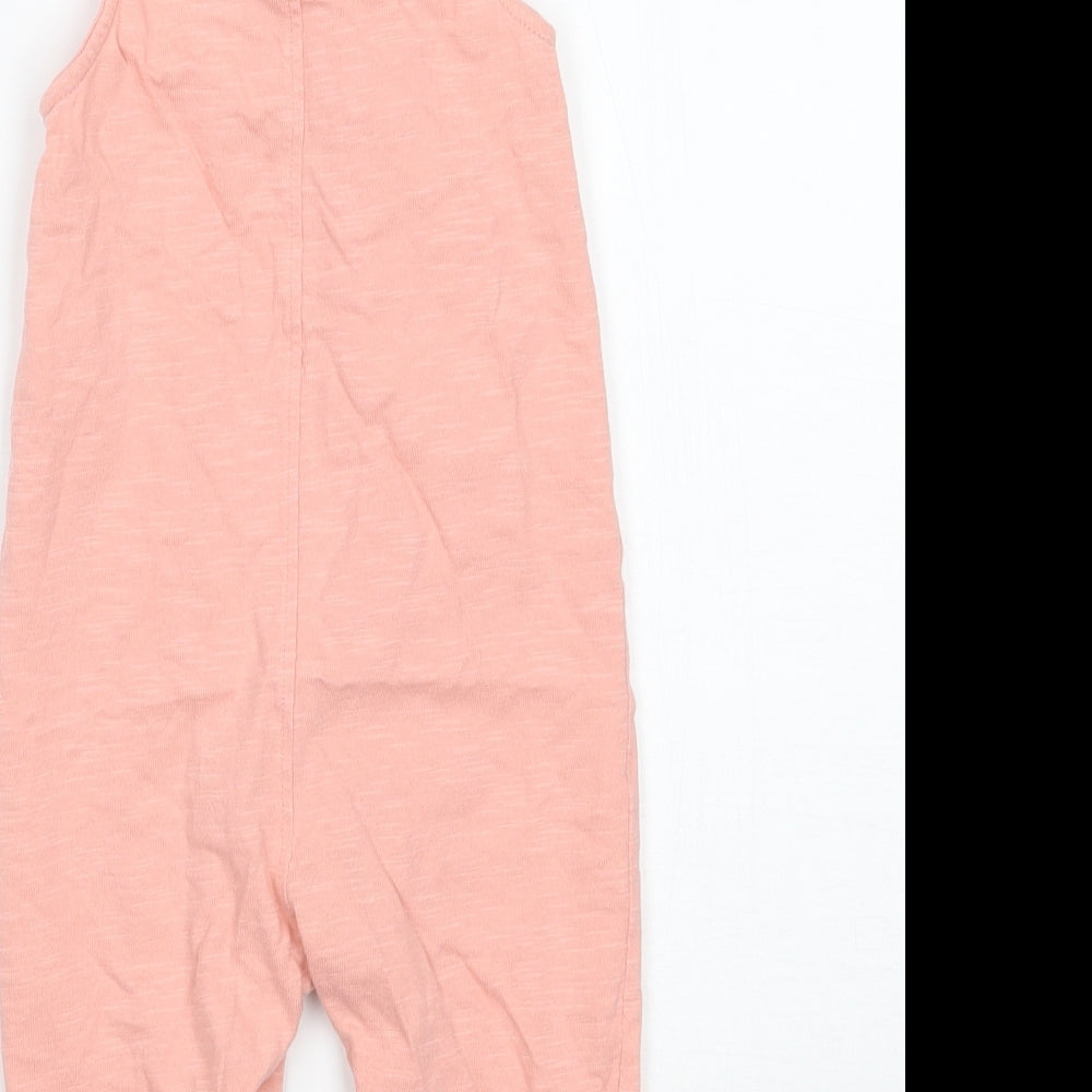 Brand and care label for Tu girls’ pink babygrow one-piece, size 3-6, months
