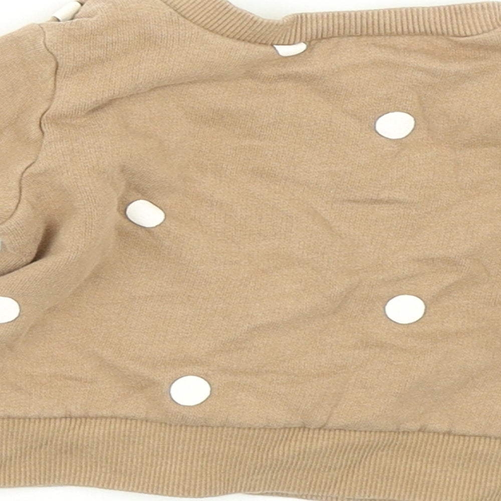 Brand and care label for H&M girls’ brown polka dot pullover t-shirt, size 0-3, months