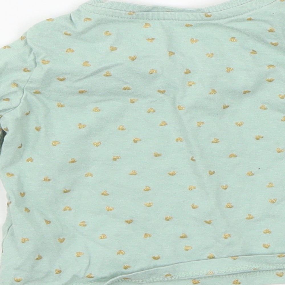 Brand and care label for Primark girls’ green polka dot jersey basic t-shirt, size 6-9, months
