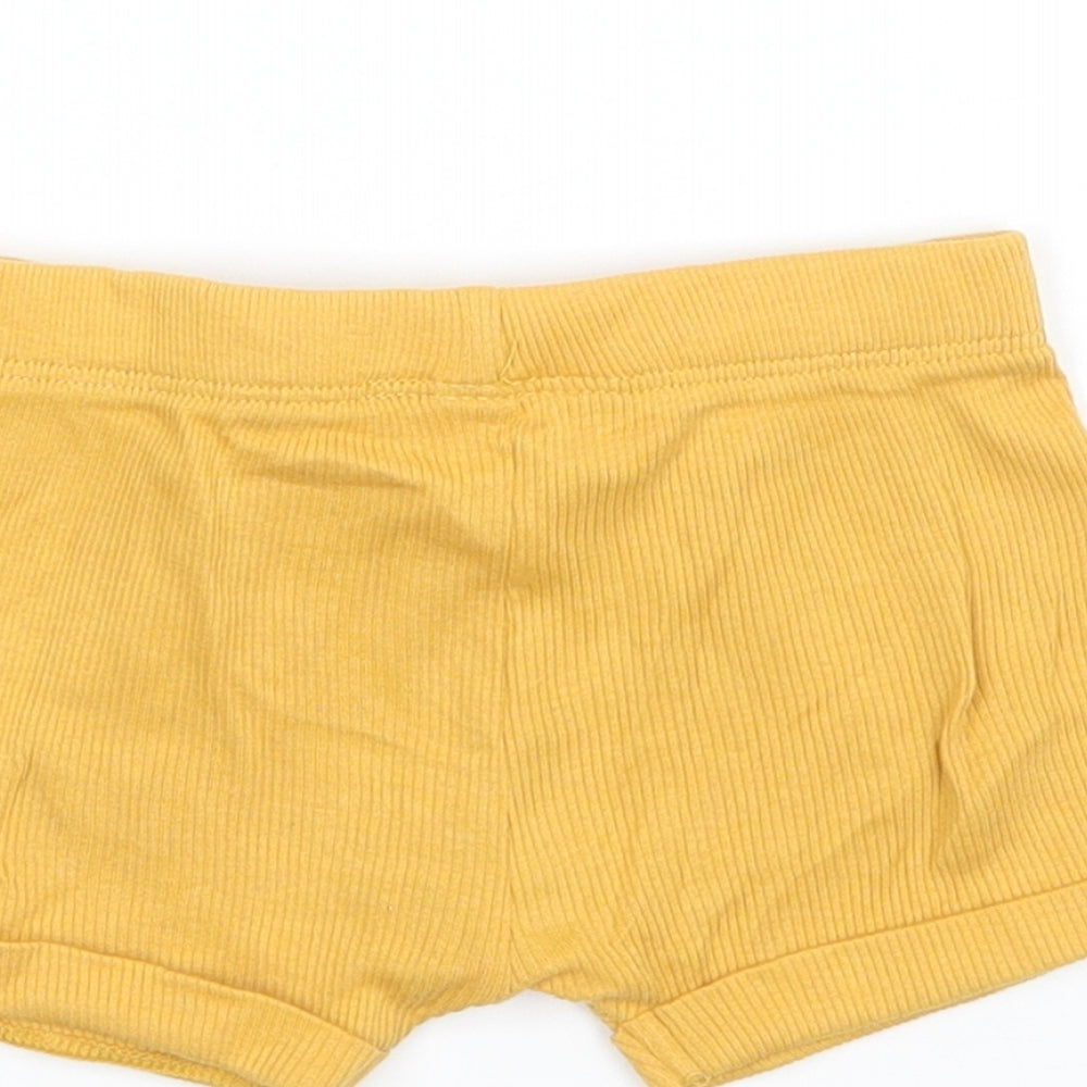Brand and care label for Tu girls’ yellow cropped trousers size newborn