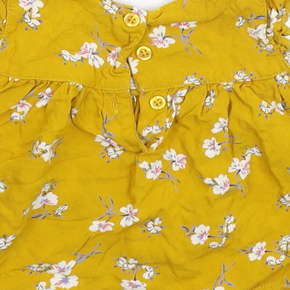 Brand and care label for Primark girls’ yellow floral basic t-shirt, size 3-6, months