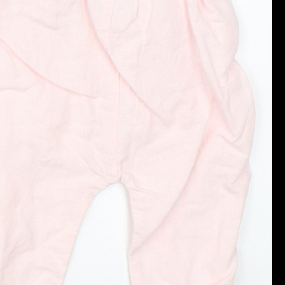 Brand and care label for Next girls’ pink pyjama pants, size 3-6, months