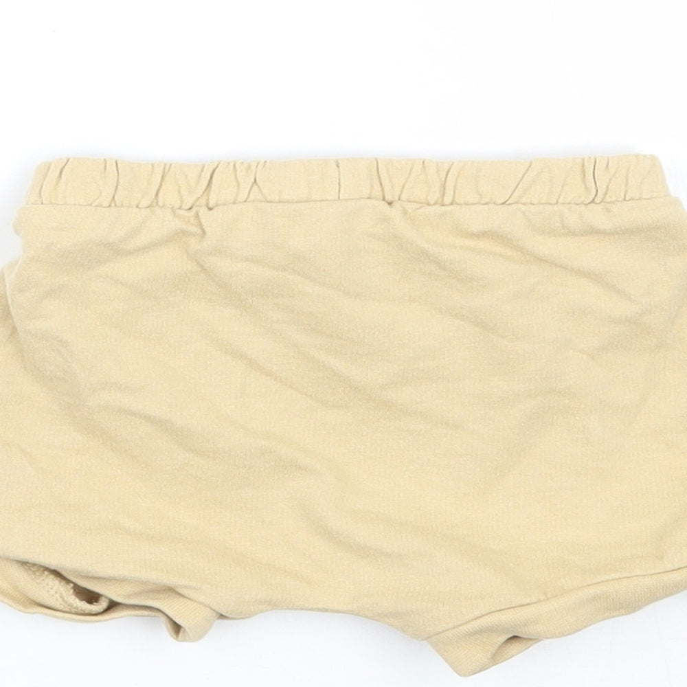 Brand and care label for Tu girls’ yellow cropped trousers, size 3-6, months