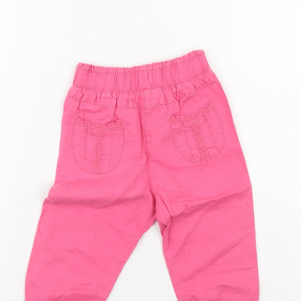 Brand and care label for Next girls’ pink pedal pusher trousers, size 12-18, months