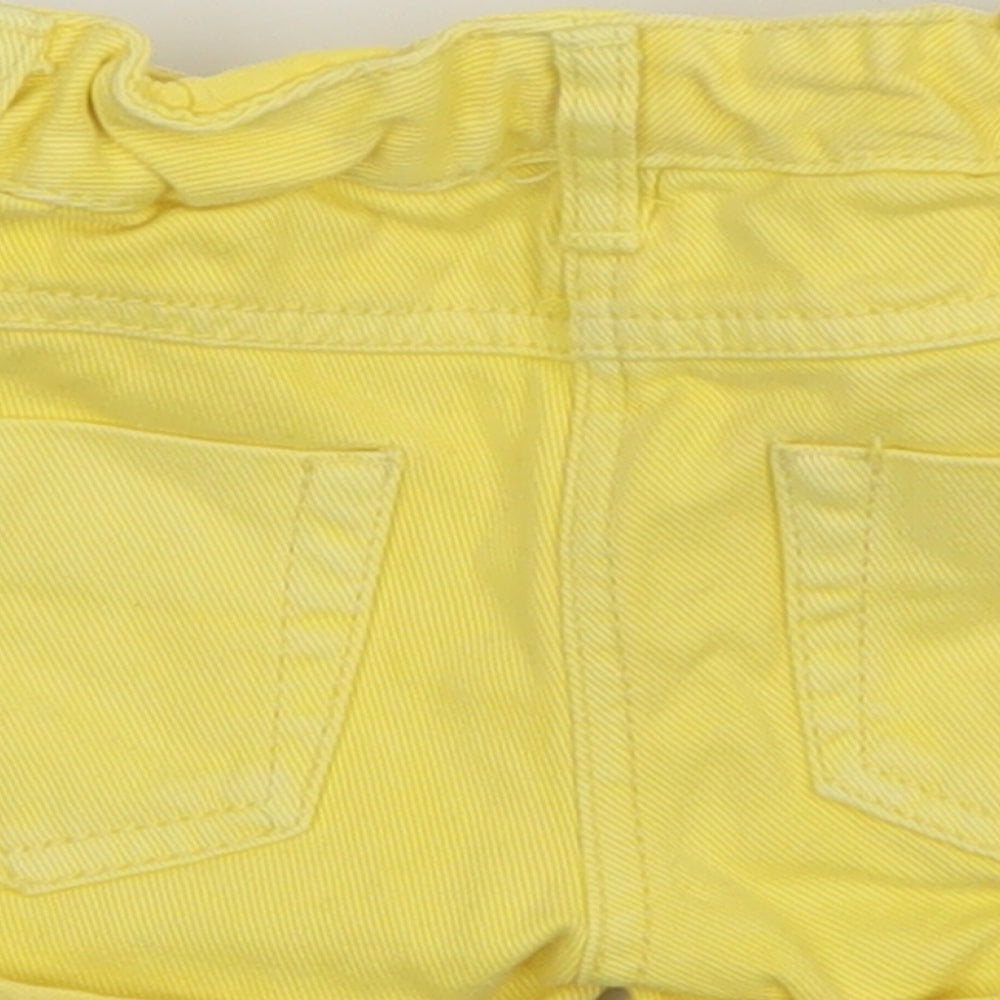 Brand and care label for F&F girls’ yellow jeans, size 12-18, months