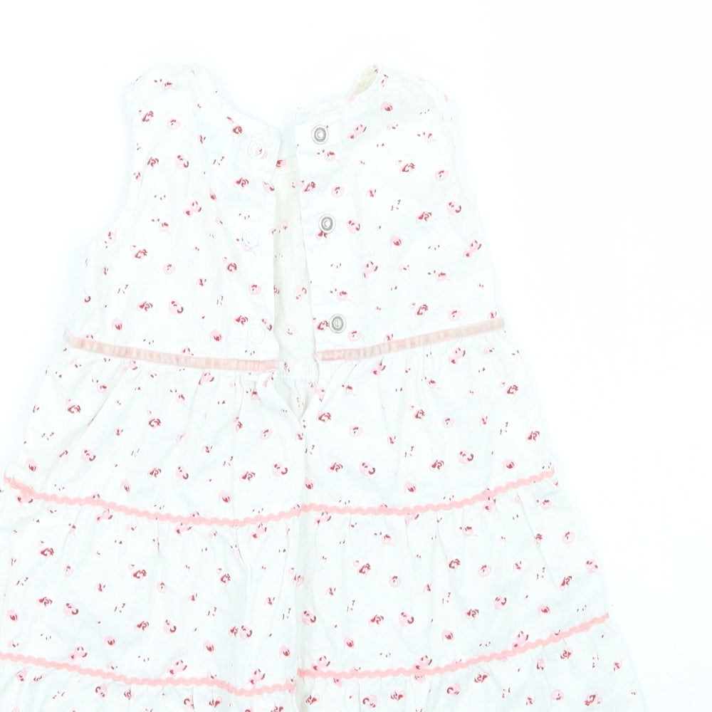 Brand and care label for Adams girls’ white floral a-line, size 3-6, months