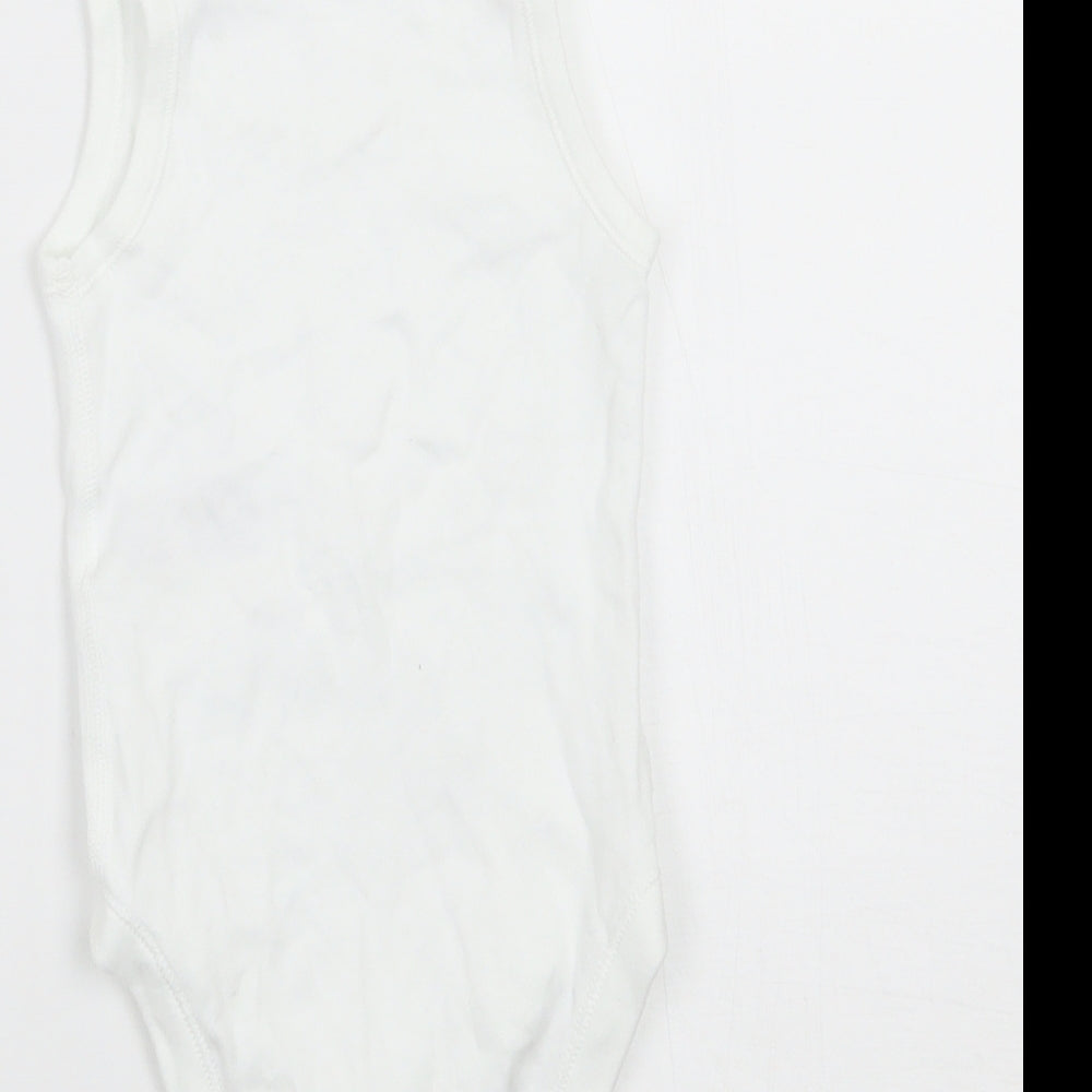 Brand and care label for Marks & Spencer boys’ white babygrow one-piece, size 6-9, months