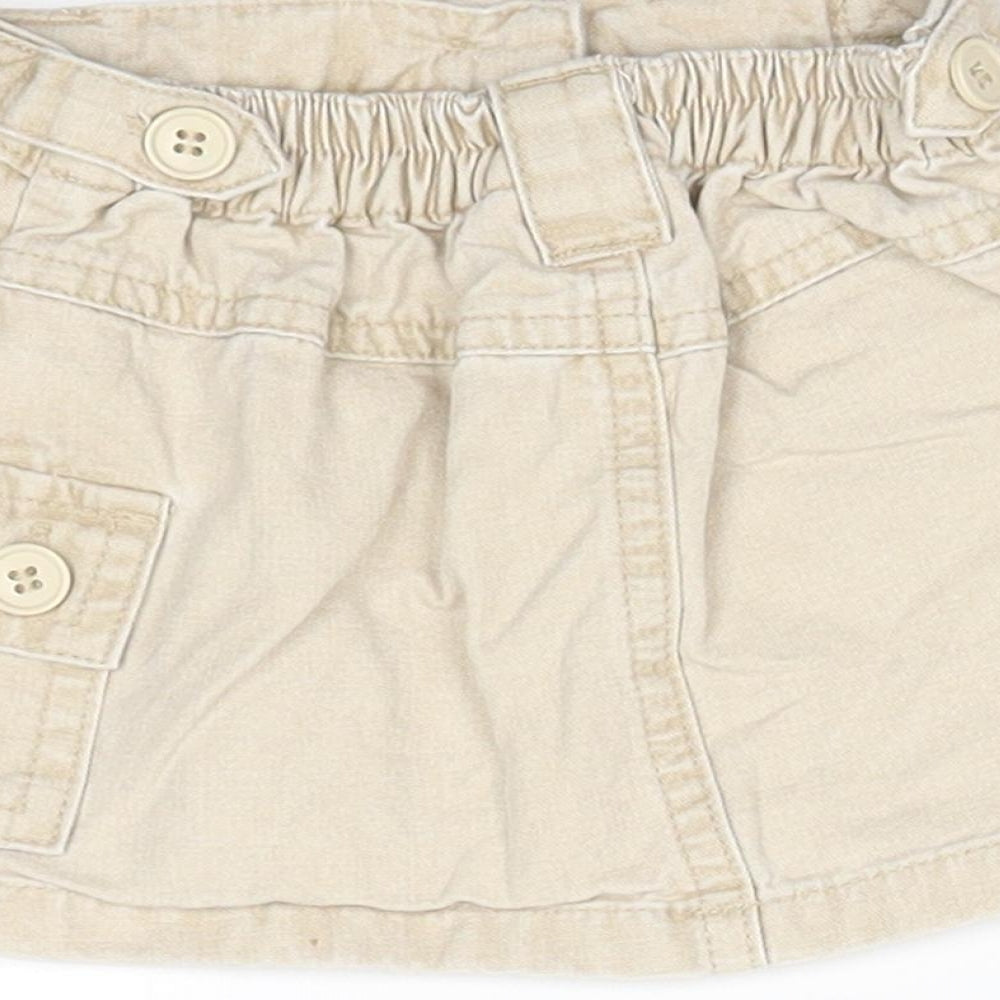 Brand and care label for Next girls’ beige a-line skirt, size 3-6, months