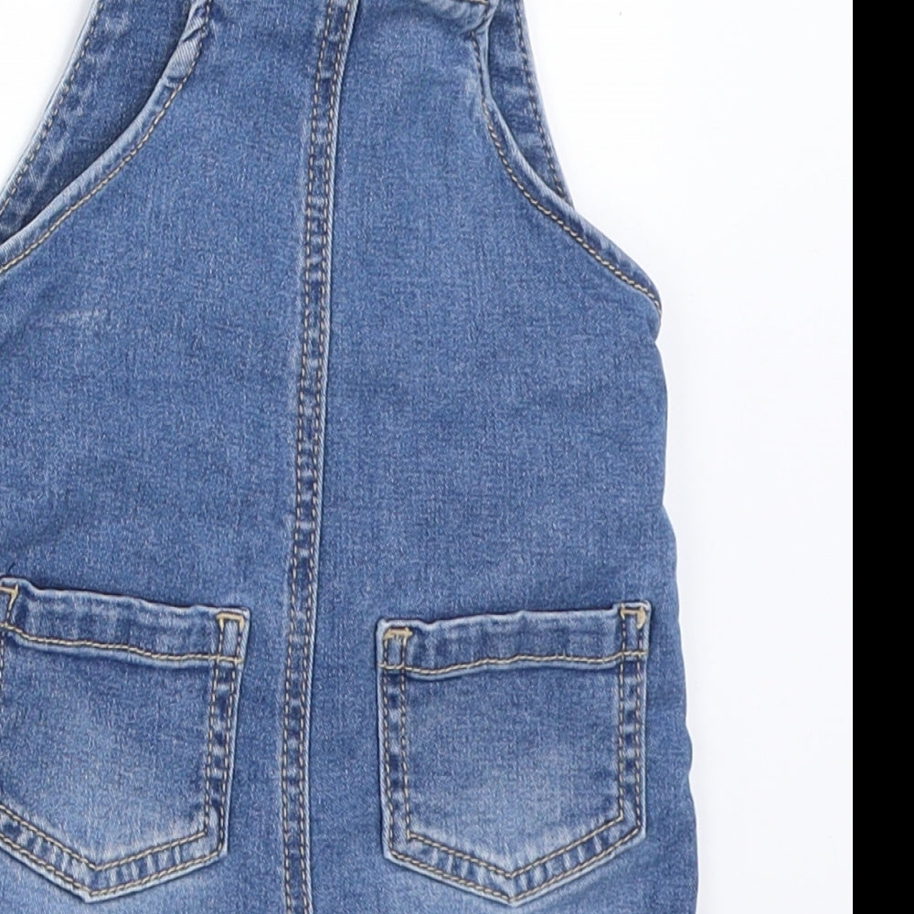 Brand and care label for F&F boys’ blue denim dungaree one-piece, size 3-6, months