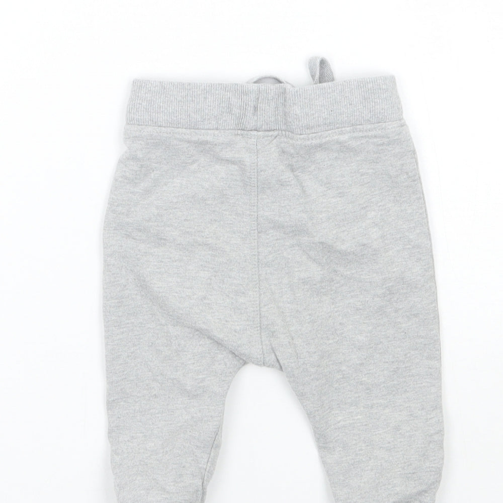 Brand and care label for Marks & Spencer Baby Grey sweatpants, size 6-9, Months
