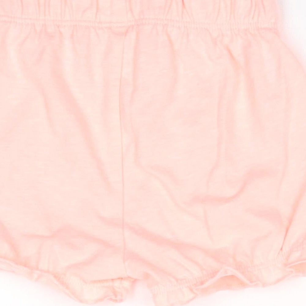 Brand and care label for George girls’ pink trousers, size 0-3, months