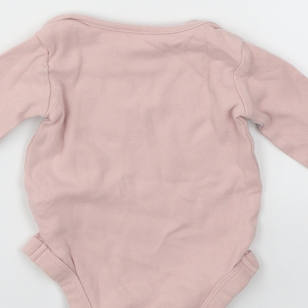 Brand and care label for Tu girls’ pink babygrow one-piece, size 3-6, months
