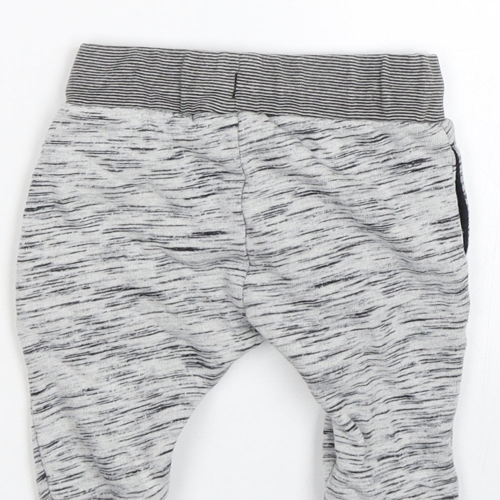 Brand and care label for Next Baby Grey sweatpants, size 3-6, Months