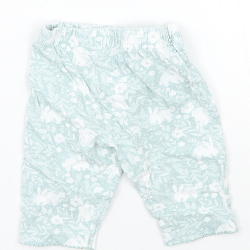 Brand and care label for Tu girls’ green floral sweatpants, size 0-3, months