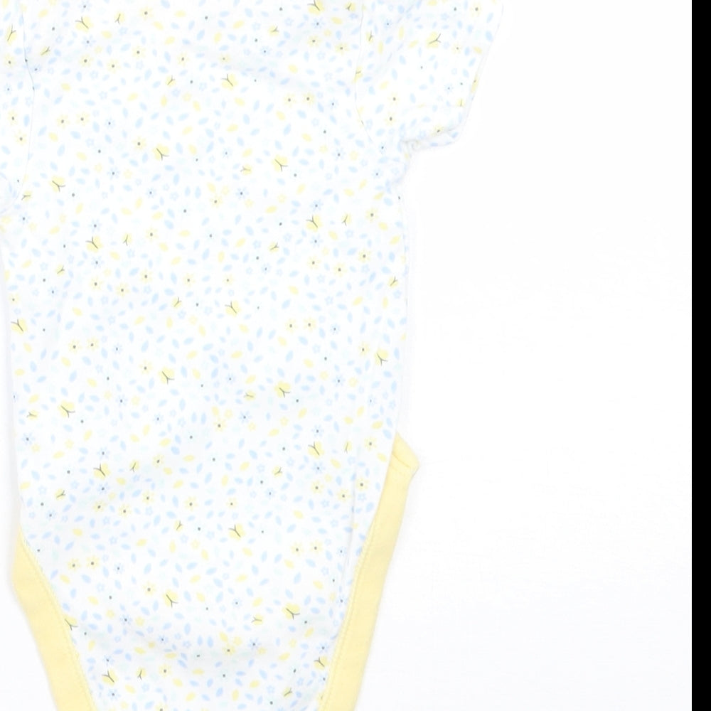 Brand and care label for George girls’ white floral babygrow one-piece, size 0-3, months