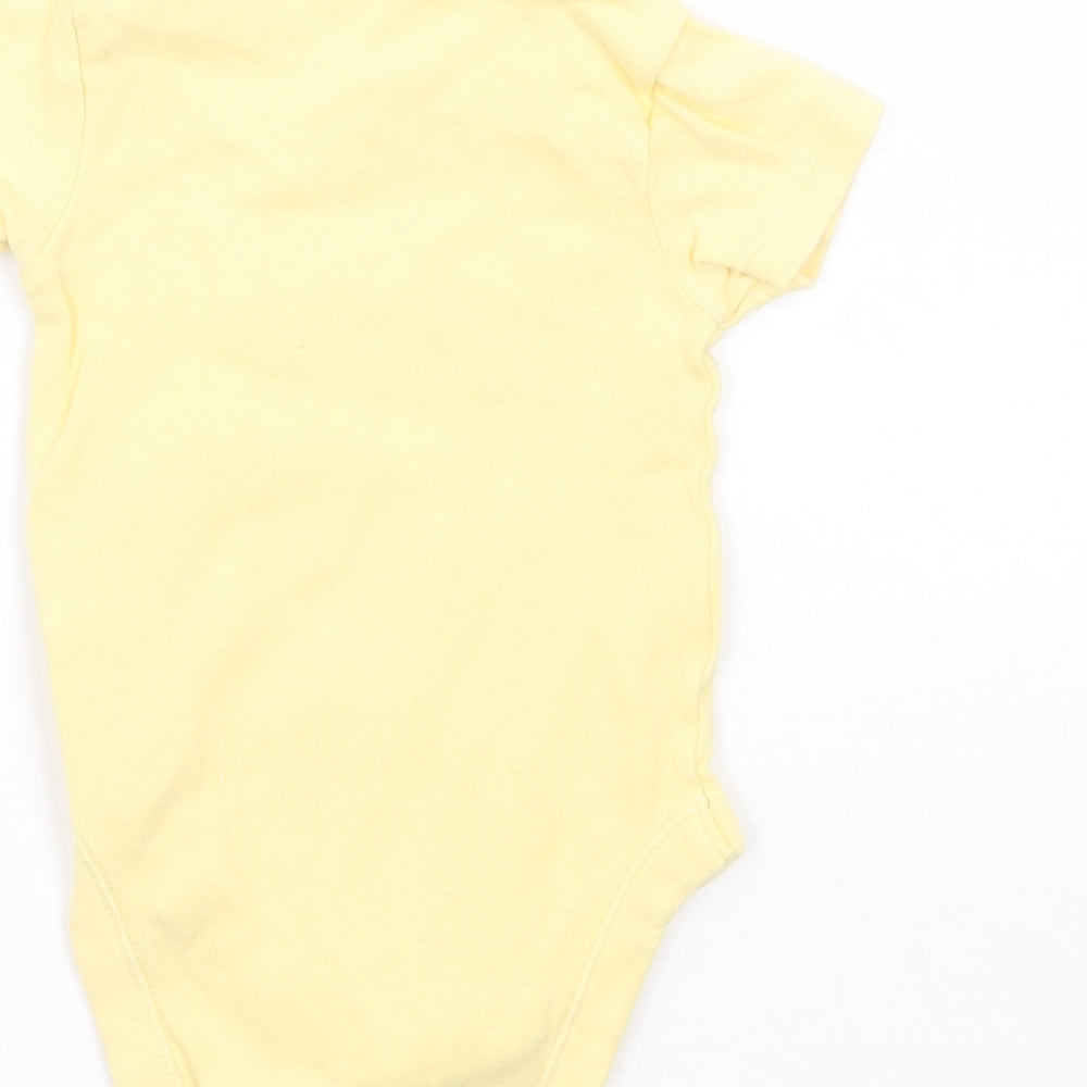 Brand and care label for George girls’ yellow babygrow one-piece, size 0-3, months