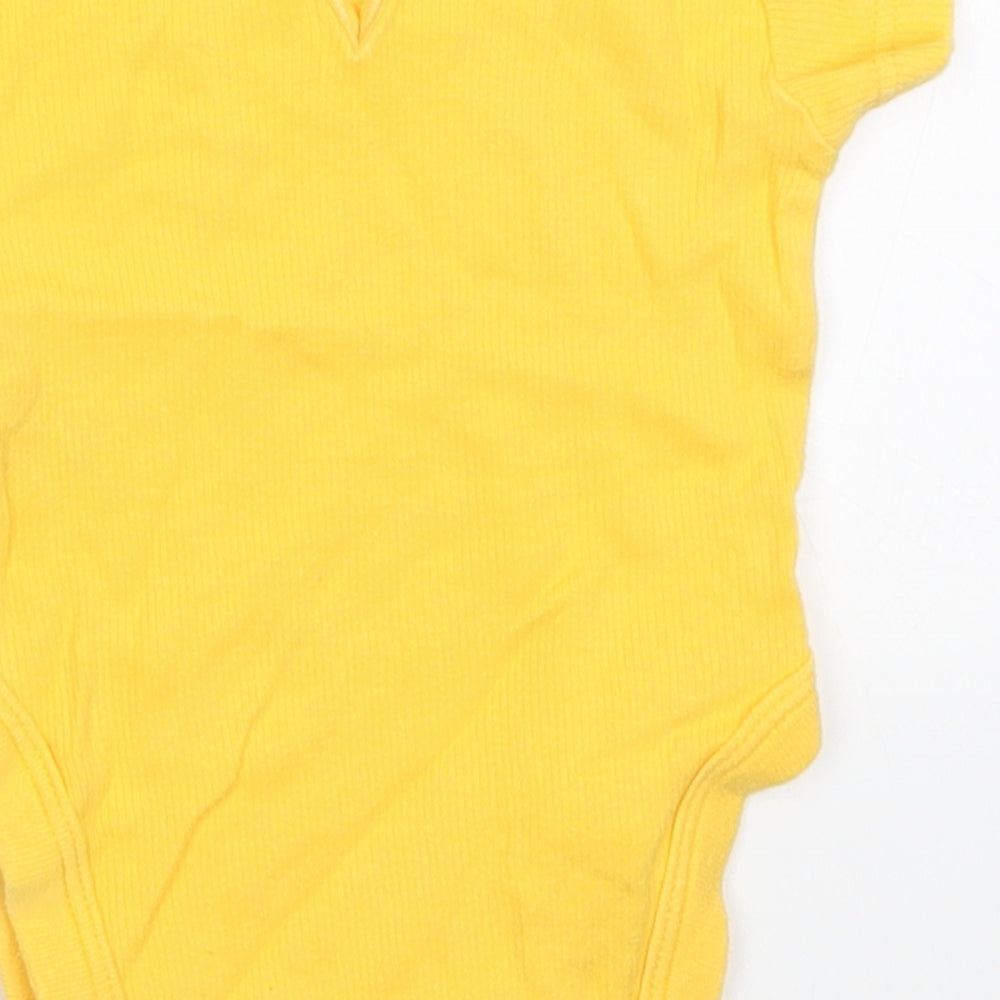 Brand and care label for Next girls’ yellow babygrow one-piece, size 0-3, months
