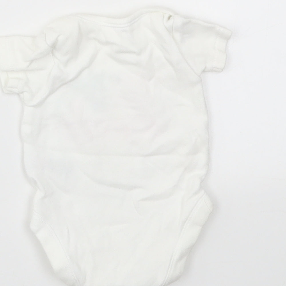 Brand and care label for Nutmeg girls’ multicoloured babygrow one-piece size newborn