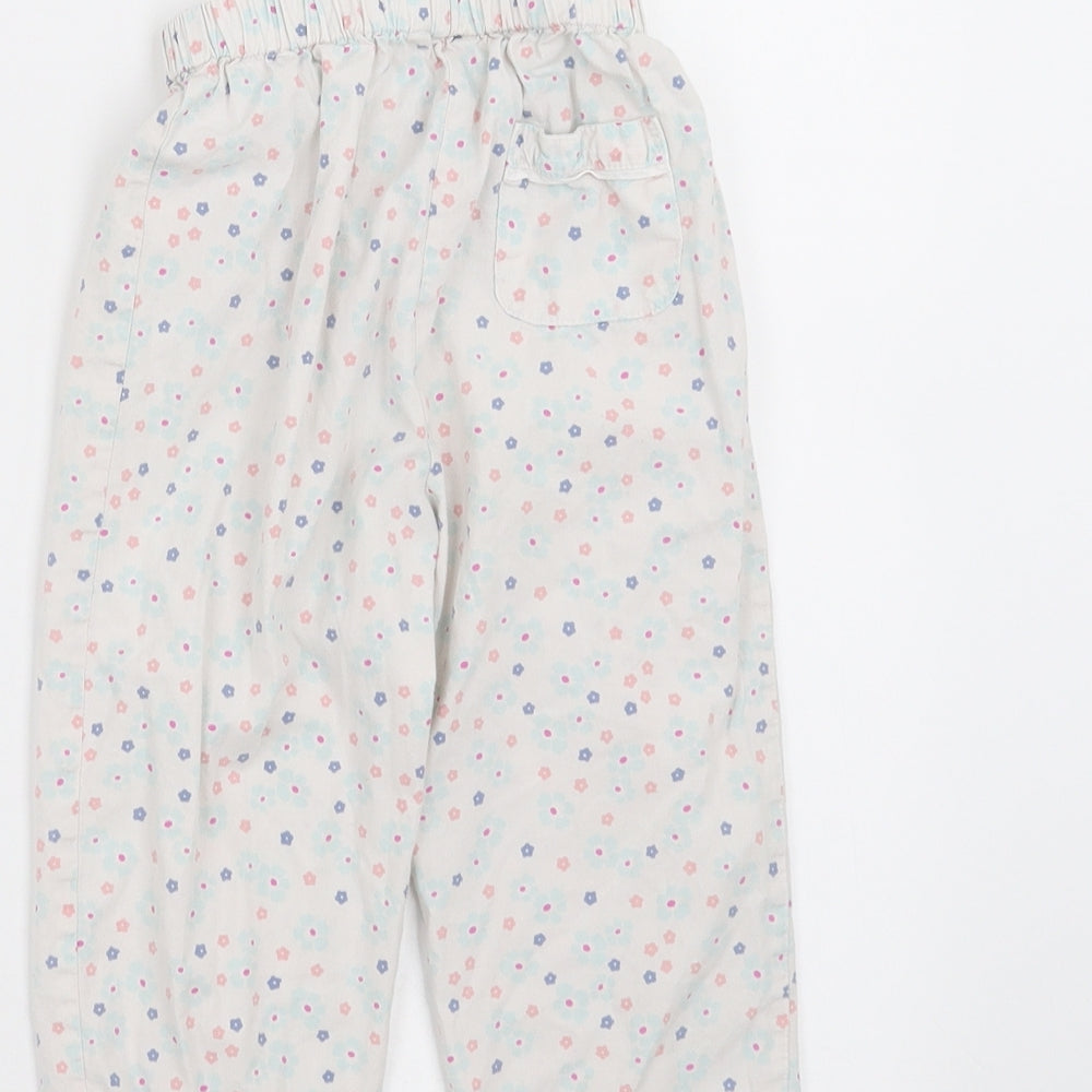 Brand and care label for John Lewis girls’ white floral pyjama pants, size 12-18, months