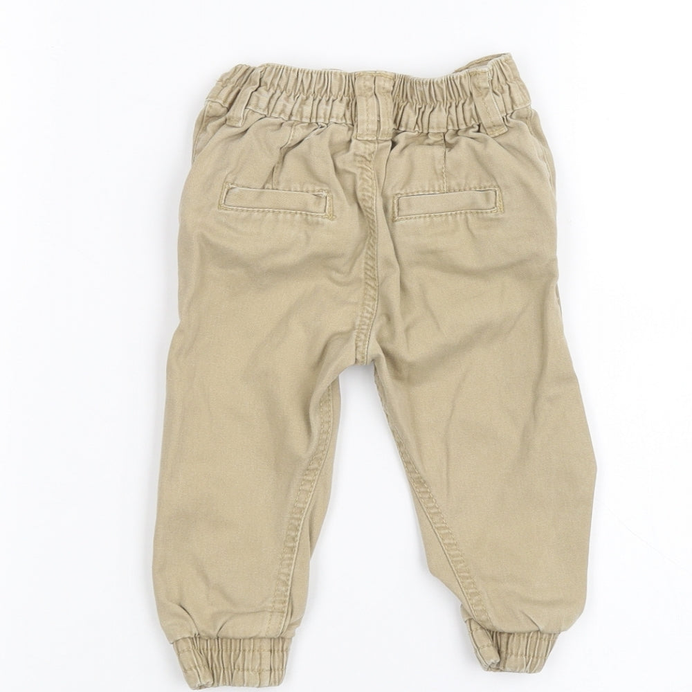 Brand and care label for Rebel Baby Brown Jeans, size 9-12, Months