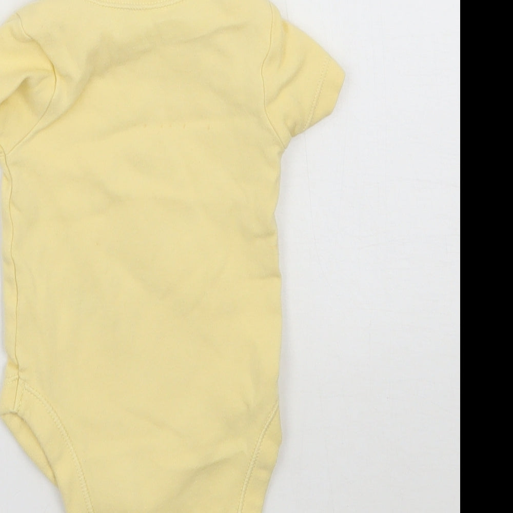 Brand and care label for George girls’ yellow babygrow one-piece, size 0-3, months