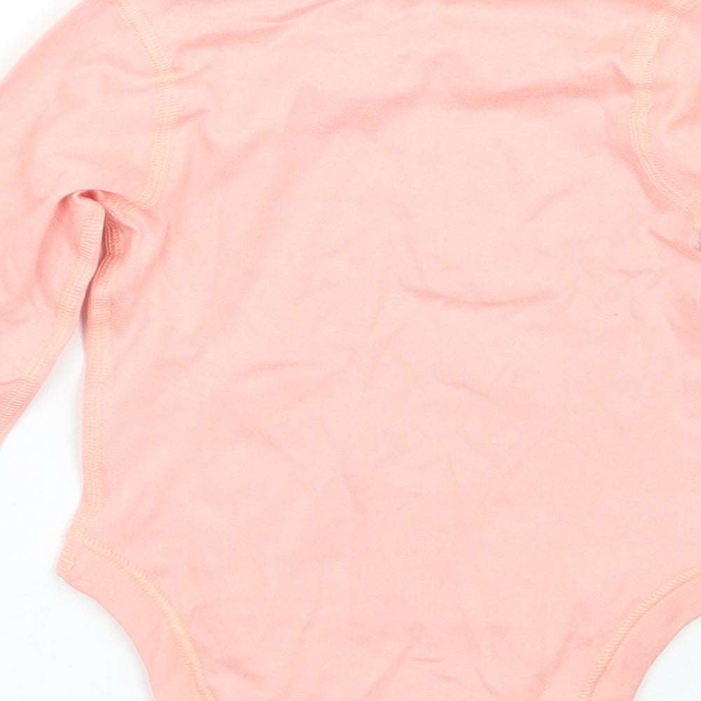 Brand and care label for Marks & Spencer girls’ pink babygrow one-piece, size 3-6, months