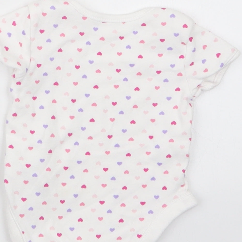 Brand and care label for George girls’ white geometric babygrow one-piece, size 3-6, months