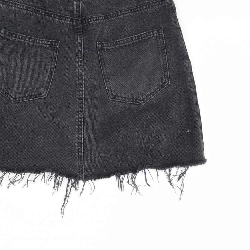 Brand and care label for Miss Selfridge women’s black denim mini skirt, size UK 6