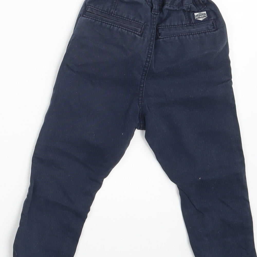 Brand and care label for Next boys’ blue denim capri trousers, size 9-12, months - waist 16in; inside leg 11 in