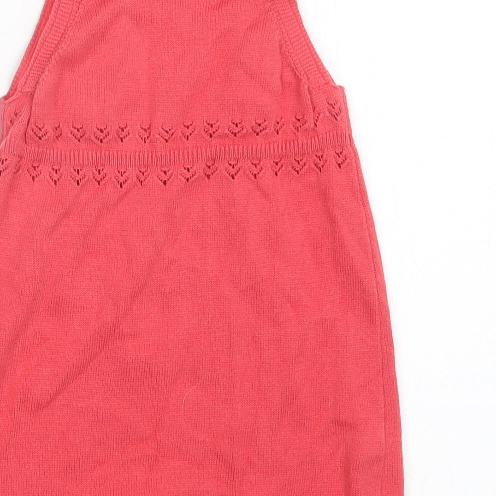 Brand and care label for Tu girls’ red jumper dress, size 6-9, months