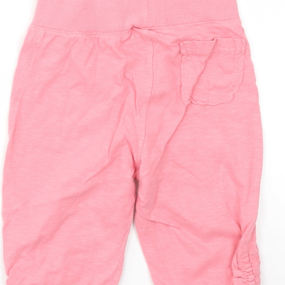 Brand and care label for Next girls’ pink capri trousers, size 12-18, months