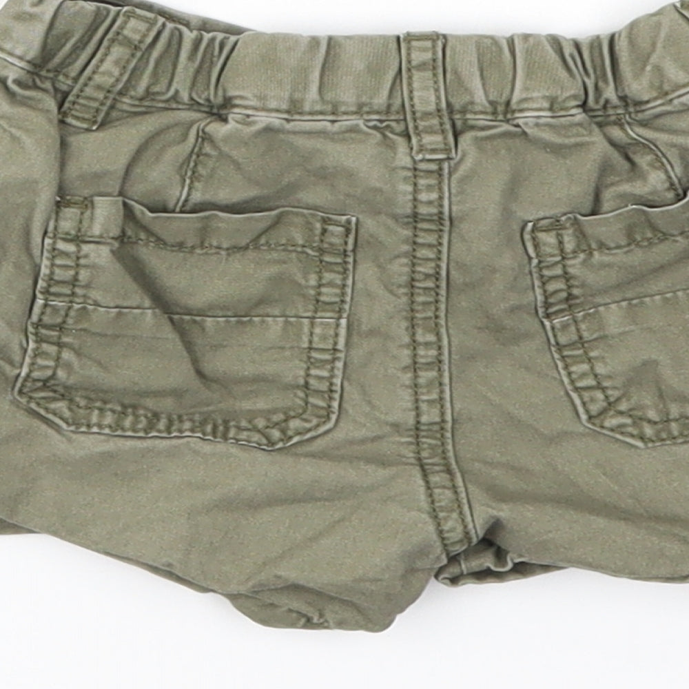 Brand and care label for Next girls’ green capri trousers, size 9-12, months