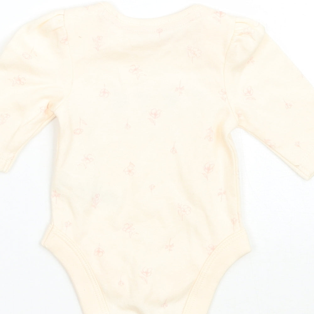 Brand and care label for George girls’ beige floral babygrow one-piece size newborn - tiny baby
