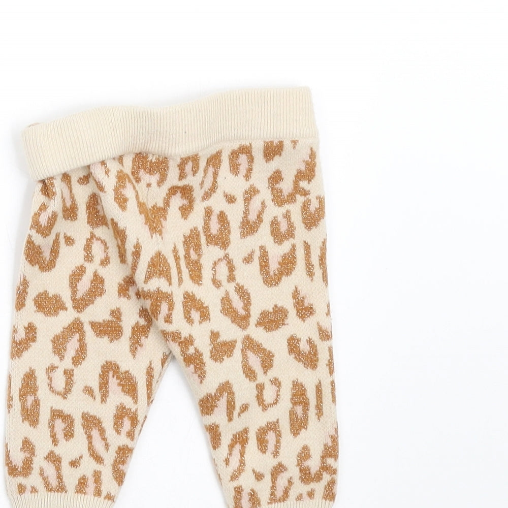 Brand and care label for River Island girls’ beige animal print knit leggings, size 0-3, months