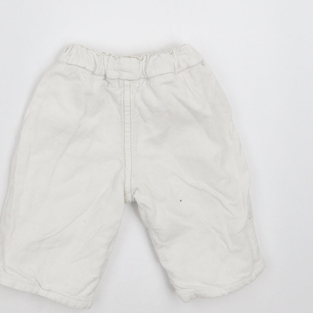 Brand and care label for BHS girls’ white trousers size newborn - embroidered detail