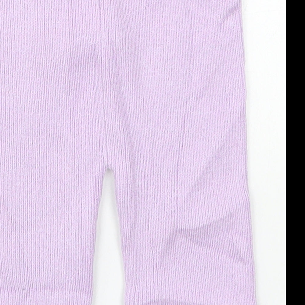 Brand and care label for Marks & Spencer girls’ purple sweatpants, size 6-9, months