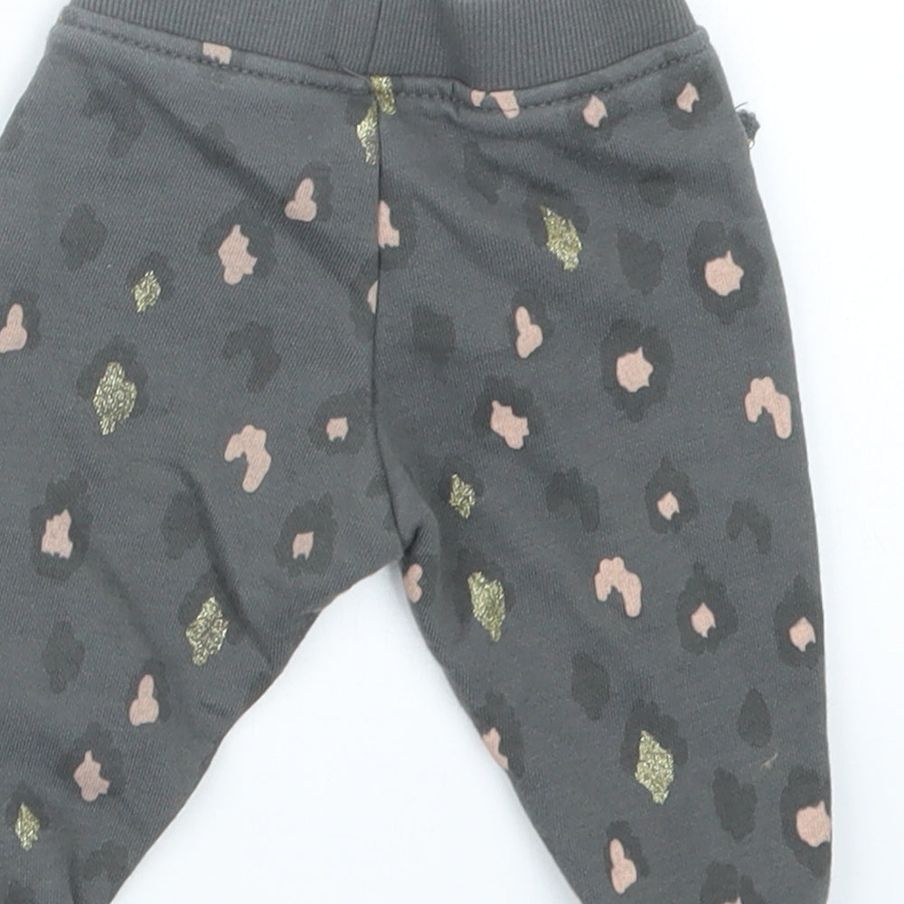 Brand and care label for Primark girls’ grey animal print jogger trousers, size 3-6, months