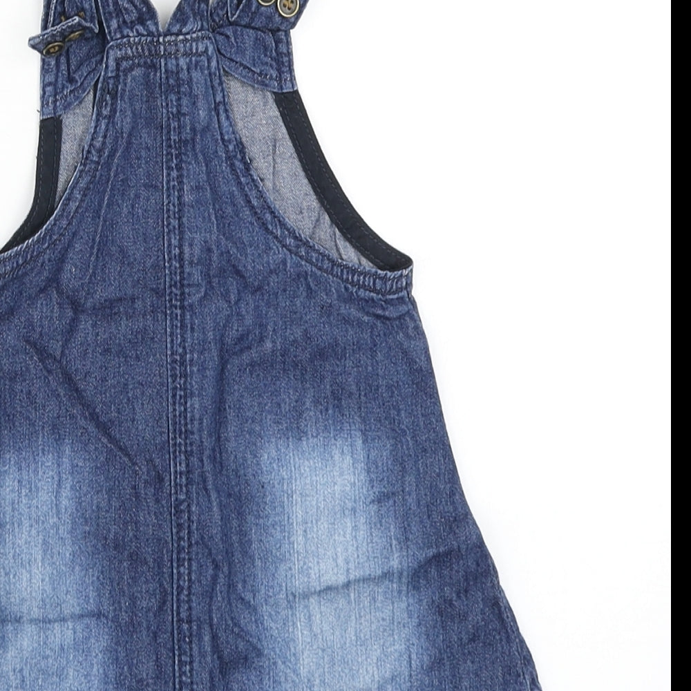 Brand and care label for Next girls’ blue denim pinafore/dungaree dress, size 9-12, months
