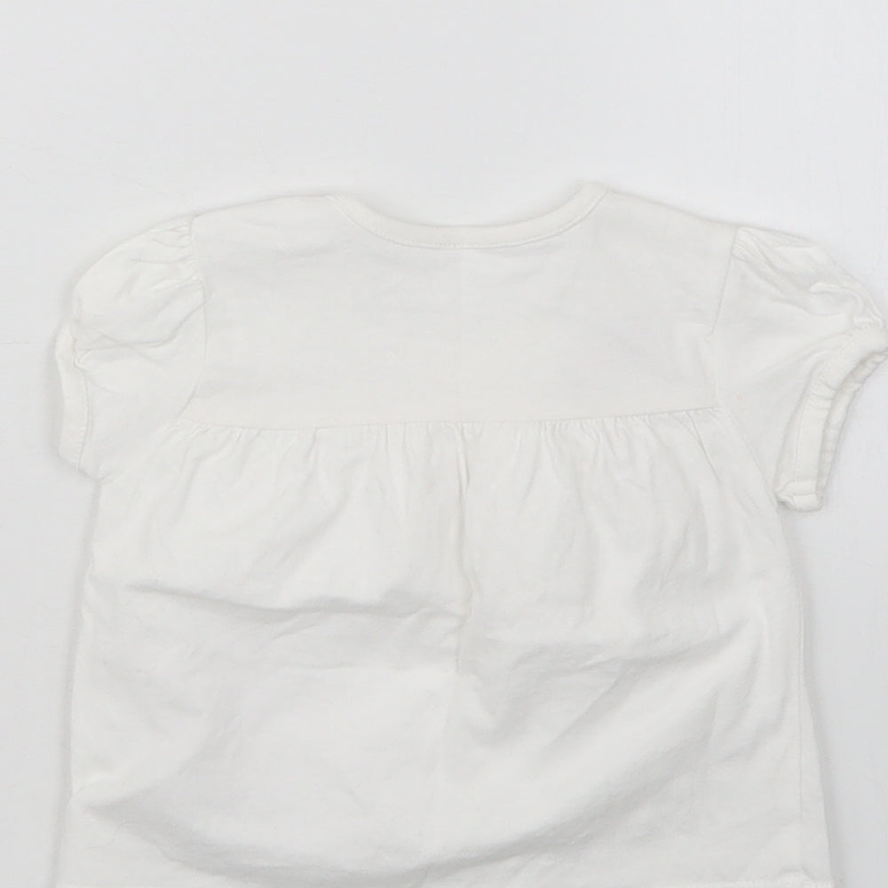 Brand and care label for Nutmeg girls’ white basic t-shirt, size 3-6, months