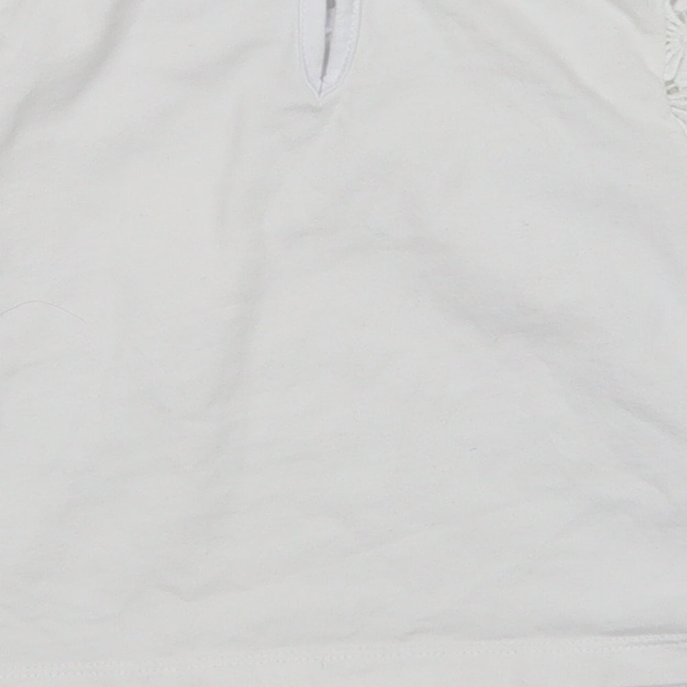 Brand and care label for Tu girls’ white floral basic t-shirt, size 6, years