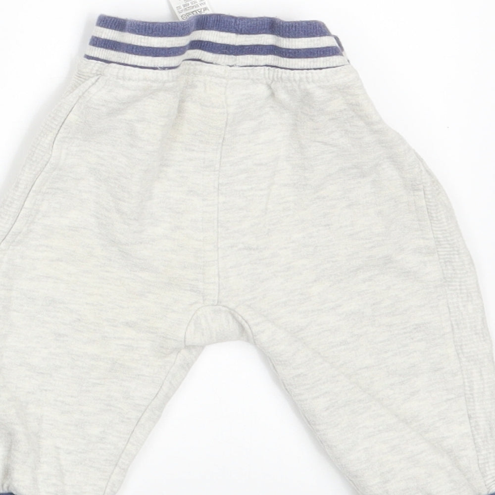 Brand and care label for George boys’ white jogger leggings, size 6-9, months - waist 14in; inside leg 7in