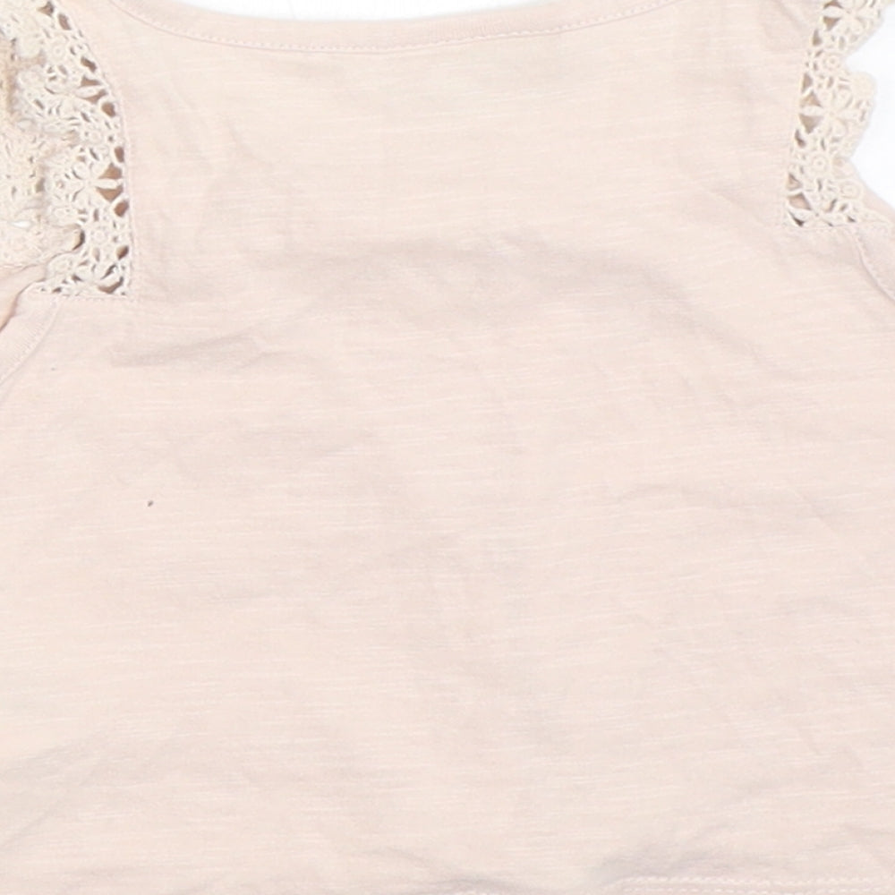 Brand and care label for Next girls’ pink basic tank, size 3, years